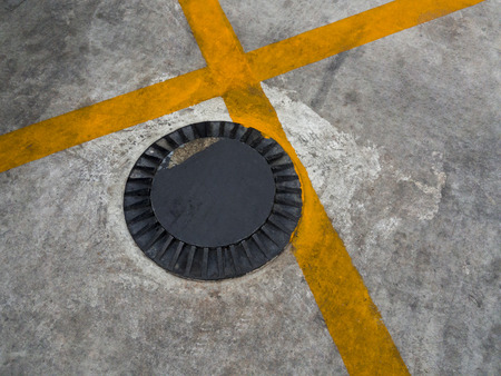 Street no parking zone signs on asphalt floor. drainage system on the roadの写真素材