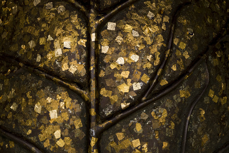 Texture of the gold leaf, Footprint of the Buddha with a sheet of gold leaf.