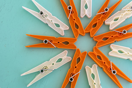 Colorful clothespins for clothes on a blue wooden background, top view. in selective focus