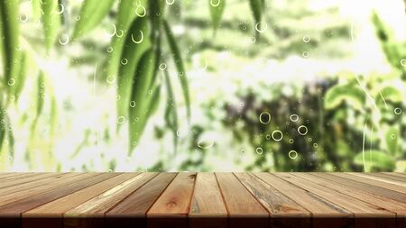 Brown grunge wood table with green leaves for product placement or editing your product or design elements. Wooden board empty table perspective.の写真素材