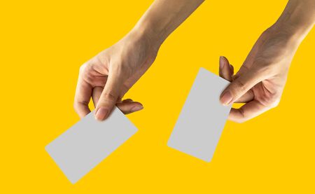 hold name card or credit card in right and left  with yellow pastel background. withの写真素材