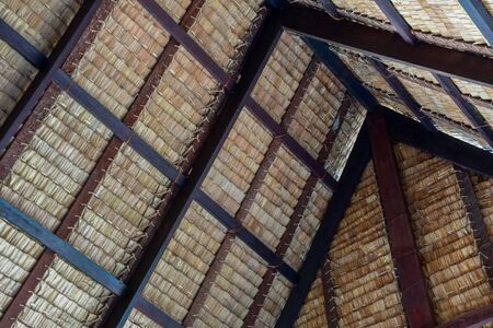 Traditional swiss thatch roof from the inside. Piece of a tap thatching that made from strips of Nipa leaves, nature leafs texture background.の写真素材