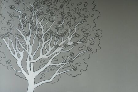 The abstract nature design of the tree with a black-gray picture of trunks and twigs in the foreground and gray birch stripes on gray walls.の写真素材