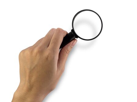 Hand holding magnifying glass on white background.の写真素材