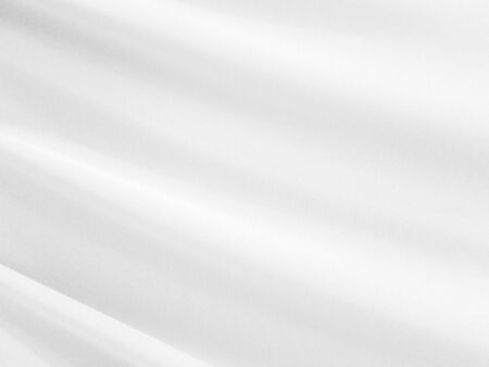 White silk satin background smooth texture background. The fabric is a light gray shining wave.の写真素材