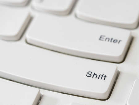 Close up of arrow keys on white keyboard of modern laptop