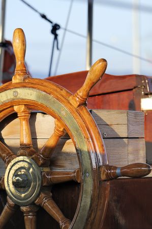 Detail of a wooden steering wheel on a vintage sailboatの写真素材