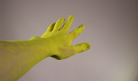 Hand dirty in yellow paint holiの写真素材