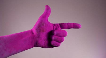 Hand thumb up stained in purple paint holiの写真素材