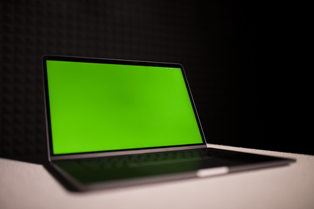 Gray laptop with green screenの写真素材
