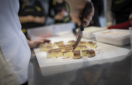 Close up of hand cutting cakeの写真素材