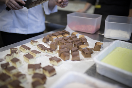 Close up of hand cutting cakeの写真素材