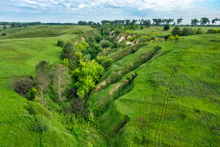 Hills slopes overgrown with green grass, nature reserve Ukrainian Iceland near Vasylkiv, Ukraine. Aerial viewの写真素材
