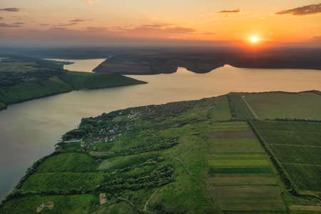 Magnificent aerial view of the Dniester River with picturesque banks during sunset. Bakota National Natural Park, Podolskie Tovtry, Ukraine. Beautiful view from a flying drone.の写真素材
