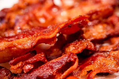 Macro view, of appetizing, tasty, fried, crispy bacon slices, close-up, meat ham to scrambled eggs, shallow depth of fieldの写真素材
