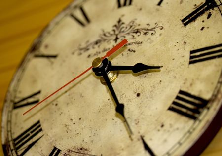 an antique wall clock with roman digit