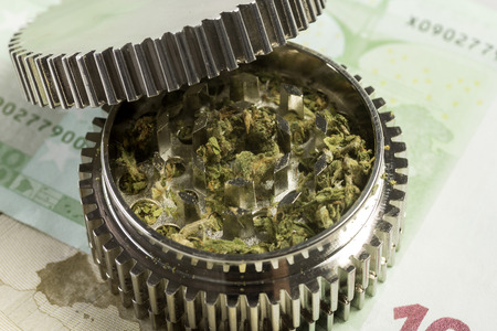 Banknotes of euros & grinder with medicinal marijuanaの写真素材
