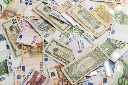 Background of lots of bills of mixed currency and value of euro and dollarsの写真素材