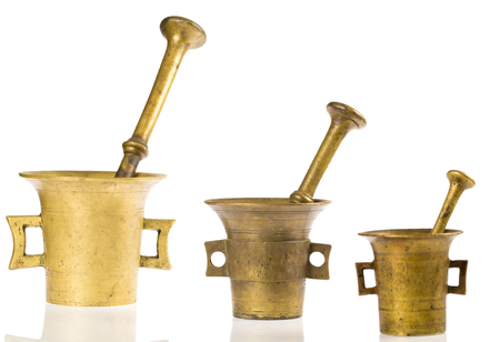 Three old bronze mortar photographed in studio on white backgroundの写真素材