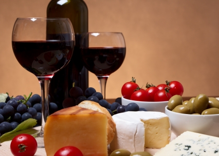 Still life with cherry tomato, red wine and cheeseの写真素材