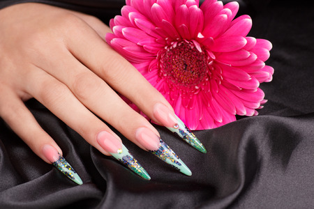 Female hands displaying beautiful polished nailsの写真素材