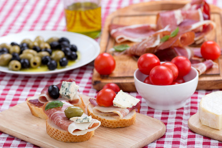sliced prosciutto with olive sheese and Cherry tomatoの写真素材