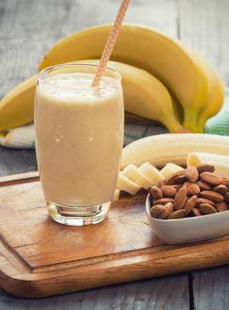 Fresh made Banana smoothie on wooden backgroundの写真素材