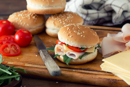 Two sandwiches with ham, vegetables and spicesの写真素材