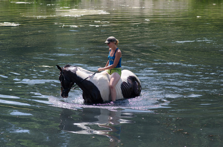 Woman bathe horse on a hot summer day, Belarusのeditorial素材
