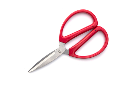 Red scissors on a white background.の写真素材