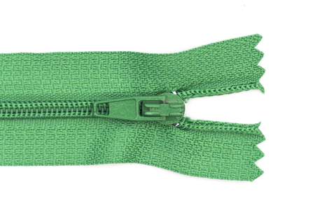 Close up green zipper isolated on white background.の写真素材