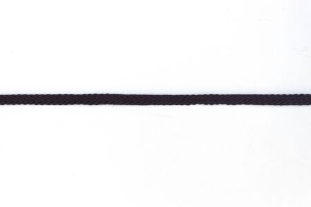 Black shoelaces on a white backgroundの写真素材