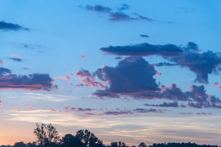The colors of late afternoon and sunset in the city of Santa Maria, Brazil, in southern Latin America. Abstract colors and heavy clouds composing the sky at dusk.の写真素材