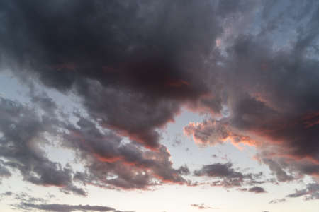 The colors of late afternoon and sunset in the city of Santa Maria, Brazil, in southern Latin America. Abstract colors and heavy clouds composing the sky at dusk.の写真素材