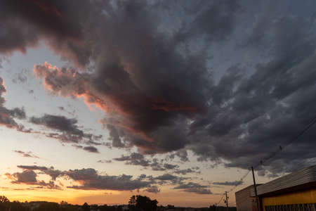 The colors of late afternoon and sunset in the city of Santa Maria, Brazil, in southern Latin America. Abstract colors and heavy clouds composing the sky at dusk.の写真素材