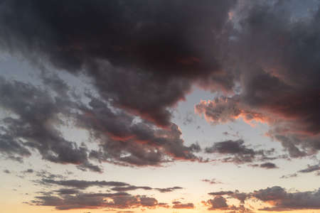 The colors of late afternoon and sunset in the city of Santa Maria, Brazil, in southern Latin America. Abstract colors and heavy clouds composing the sky at dusk.の写真素材