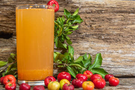 Natural juice of acerola (Malpighia emarginata). Tropical fruit. Drink based on aceroleira fruits. Glass. Refreshing drink. Fruits and drinks from Brazil.の写真素材