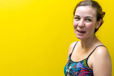 Blonde and Brazilian woman on a yellow background. Female beauty. Young woman in colorful clothes. A...