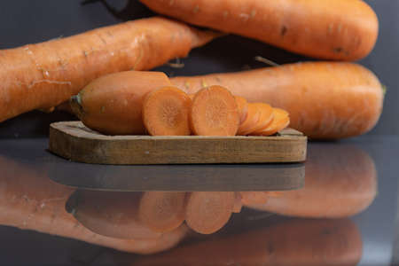 Carrot (Daucus carota) in natura. Vegetable for salads. Wooden tray. Vegetable used in Brazilian...