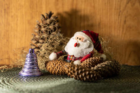 Decoration for Christmas Day where a Santa Claus appears among pine cones and other props that bring the Christmas Day motifs. Christian feast. Christmas decoration.の写真素材