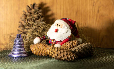 Decoration for Christmas Day where a Santa Claus appears among pine cones and other props that bring the Christmas Day motifs. Christian feast. Christmas decoration.の写真素材