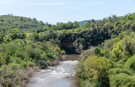 Rural landscape on the bank of Jaguarizinho river, river that bathes the municipality of Jaguari, RS, Brazil. Region of tourism and natural beauty. Small country town where grapes and wines are grown.の写真素材