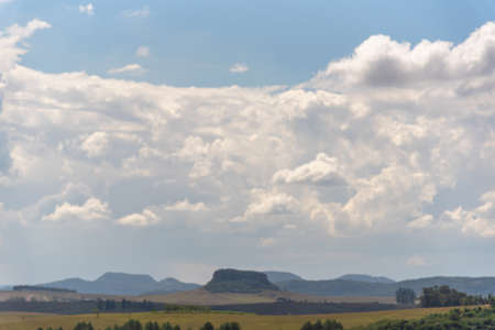 Rural landscape. Agriculture fields. Farm area and grain production. Blue sky. Cumulonimbus clouds....