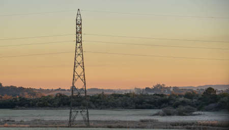 Electricity tower. Energy transmission infrastructure in Brazil. Cold and winter. Rural landscape of the frozen fields of the pampa biome. Ice formation.の写真素材