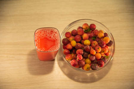 Fresh fruits and juices. Acerola is a fruit rich in vitamin C, widely used in juices and ice cream. It has long been known for its tonic and anti-infectious effects. Tropical fruits from Brazil.の写真素材