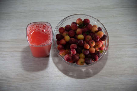Fresh fruits and juices. Acerola is a fruit rich in vitamin C, widely used in juices and ice cream. It has long been known for its tonic and anti-infectious effects. Tropical fruits from Brazil.の写真素材