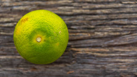 Orange fruits on a wooden background. fruit rich in vitamin C, whose main functions are to assist...