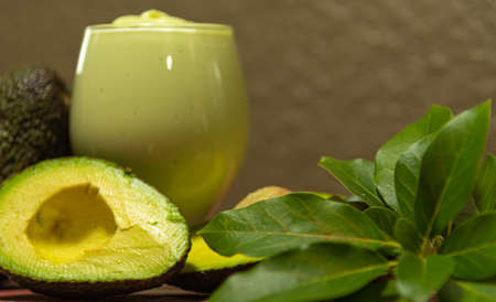 American persea. Avocado cream. Tropical fruit. Guacamole. Avocado whole and in halves. Green...