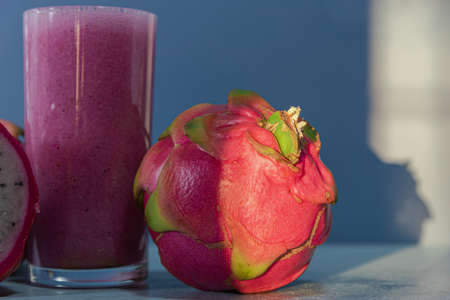 Glass cup with pitaya juice, an exotic fruit also known as dragon fruit, with a neutral flavor, rich in nutrients. Refreshing, natural and detox drink. Pink Juice.の写真素材
