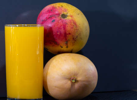 Mango juice. Fresh fruits. Exotic fruit and rich in fiber. Detox and antioxidant drink. Natural health. Refreshing drink. Tasty food. Culinary delicacy. Ingredient for dessertsの写真素材